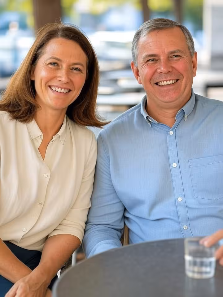 Mature couple in their fifties meeting for first coffee date at outdoor cafe, friendly conversation